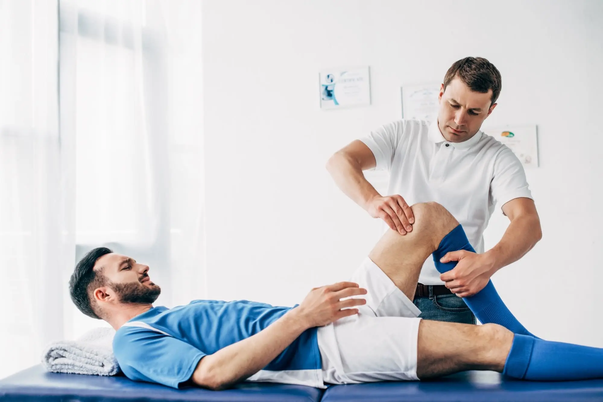 Physiotherapist Massaging Leg Of Football Player L 2022 12 16 16 17 01 Utc
